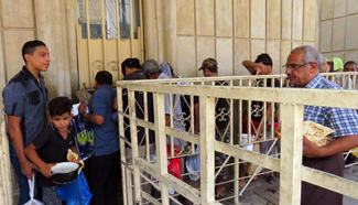 Displaced civilians receive aids at a mosque in Baghdad