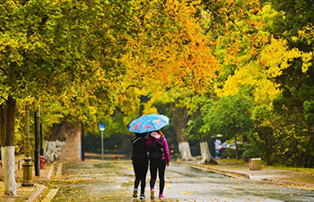 Tourists go sightseeing in rain at Badaguan scenic area in Qingdao